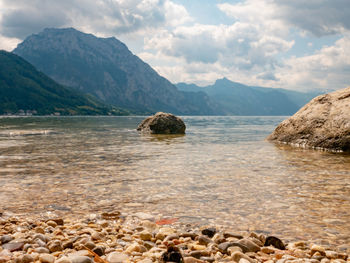 Scenic view of sea and mountains against sky