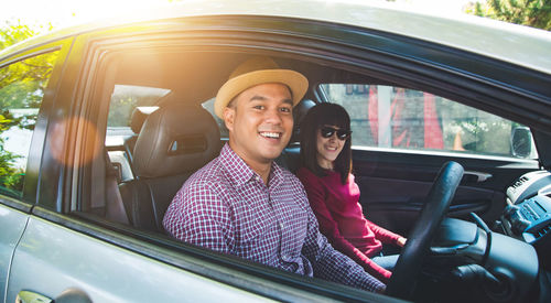 Portrait of smiling man sitting in car