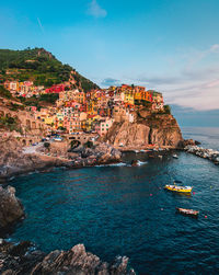 Scenic view of sea by buildings against sky