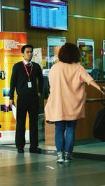 Rear view of men standing in office