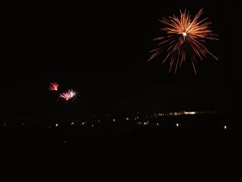 Low angle view of firework display at night