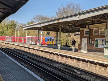 Train at railroad station against clear sky