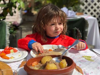 High angle view of woman having food on table