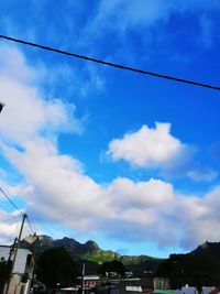 Low angle view of cables against blue sky