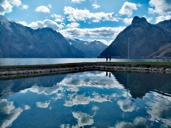 Scenic view of lake and mountains against sky