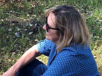 Side view of woman looking away on field