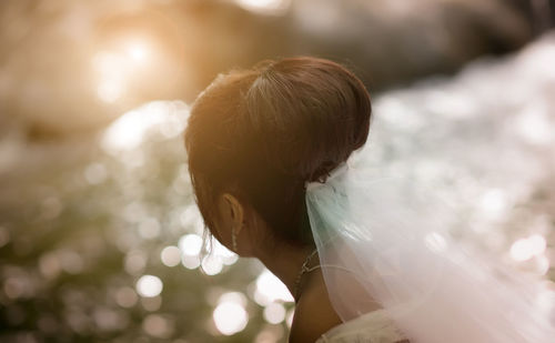 Bride in wedding dress looking away