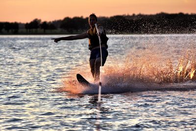 Full length of woman jumping in water