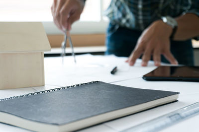 Midsection of woman working on table