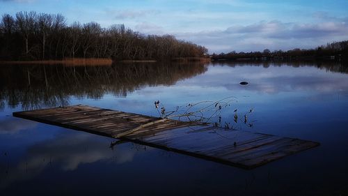 Pier on lake against sky