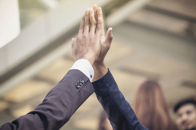 Close-up of men high fiving