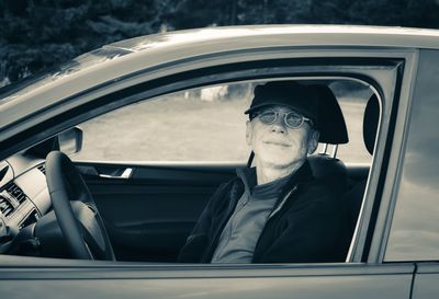 Portrait of man sitting in car