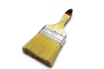 High angle view of paintbrushes against white background