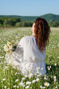 Rear view of woman with flowers