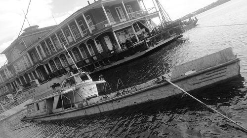 Boat moored on river against sky