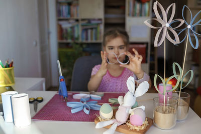 Close-up of girl doing craft at home