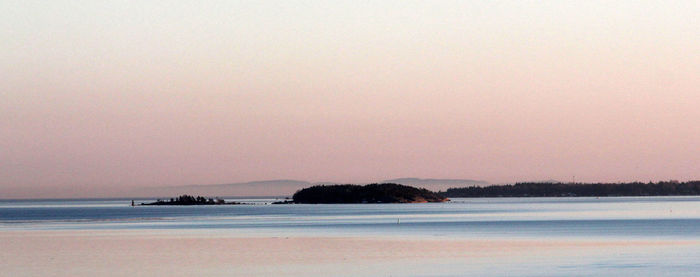 Scenic view of sea against clear sky during sunset