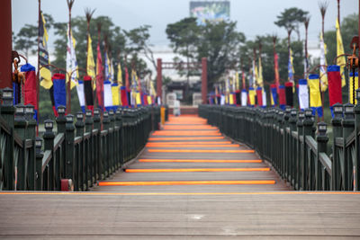 Empty walkway amidst flags at semiwon park