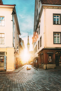 Street amidst buildings against sky in city