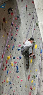 Full length of boy climbing on wall