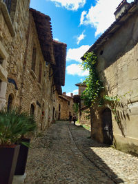 Narrow alley amidst buildings against sky