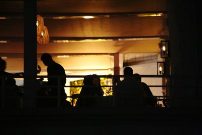 Silhouette people standing in corridor of building