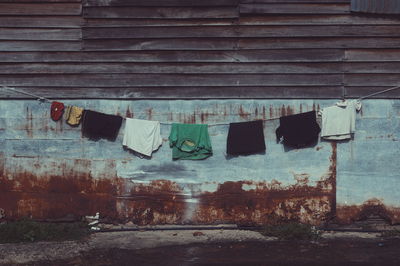 Laundries hanging on clothesline outside house