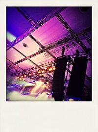 Low angle view of illuminated ferris wheel against sky