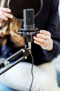 Midsection of man holding microphone