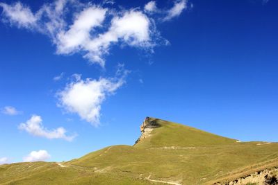 Low angle view of mountain against blue sky