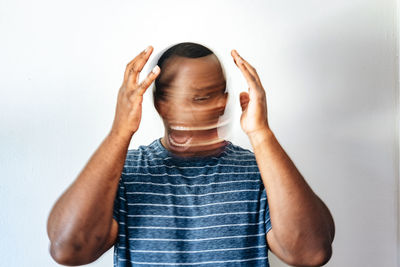 Midsection of woman wearing hat against wall