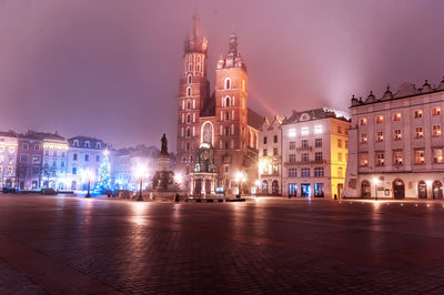 Illuminated buildings in city at night