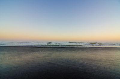 Scenic view of sea against clear sky during sunset