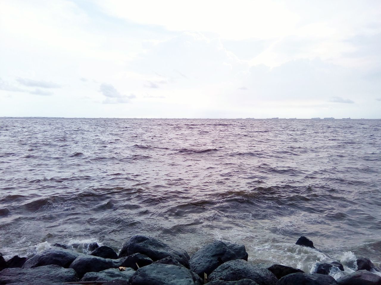 sea, water, horizon over water, scenics, tranquil scene, beauty in nature, sky, tranquility, nature, rippled, seascape, rock - object, wave, idyllic, cloud - sky, waterfront, day, outdoors, remote, no people