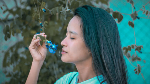 Close-up of young woman holding flower