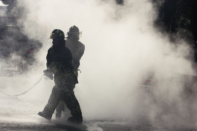 Silhouette firemen on street