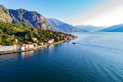 Scenic view of lake and mountains against blue sky