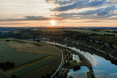 High angle view of road by city against sky during sunset