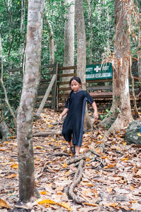 Full length of young woman in forest