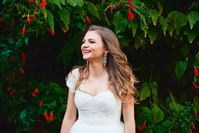 Portrait of a smiling young woman standing outdoors