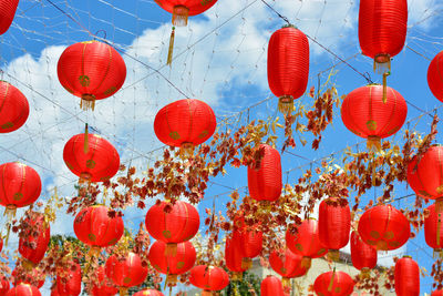 Low angle view of lanterns hanging against sky