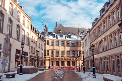 Buildings in city against sky during winter