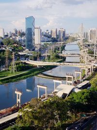 City by river and buildings against sky, marginal pinheiros, são paulo, brazil