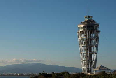 Low angle view of lighthouse against clear blue sky