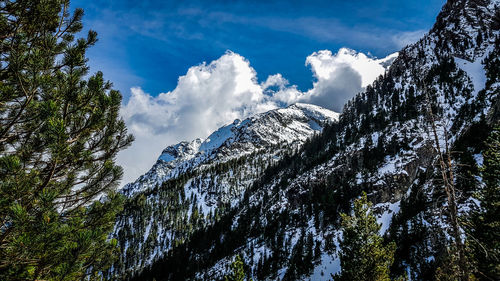 Low angle view of snowcapped mountains against sky