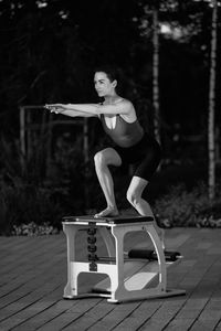 Portrait of young woman exercising in park