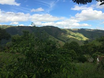 Scenic view of mountains against cloudy sky