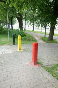 Road by footpath by street in city