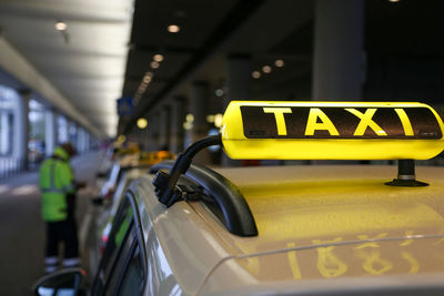 Close-up of yellow sign on car