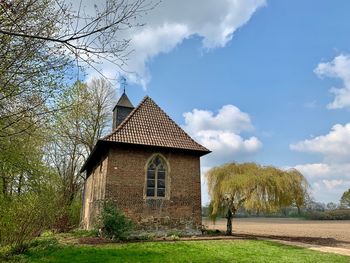 House on field against sky